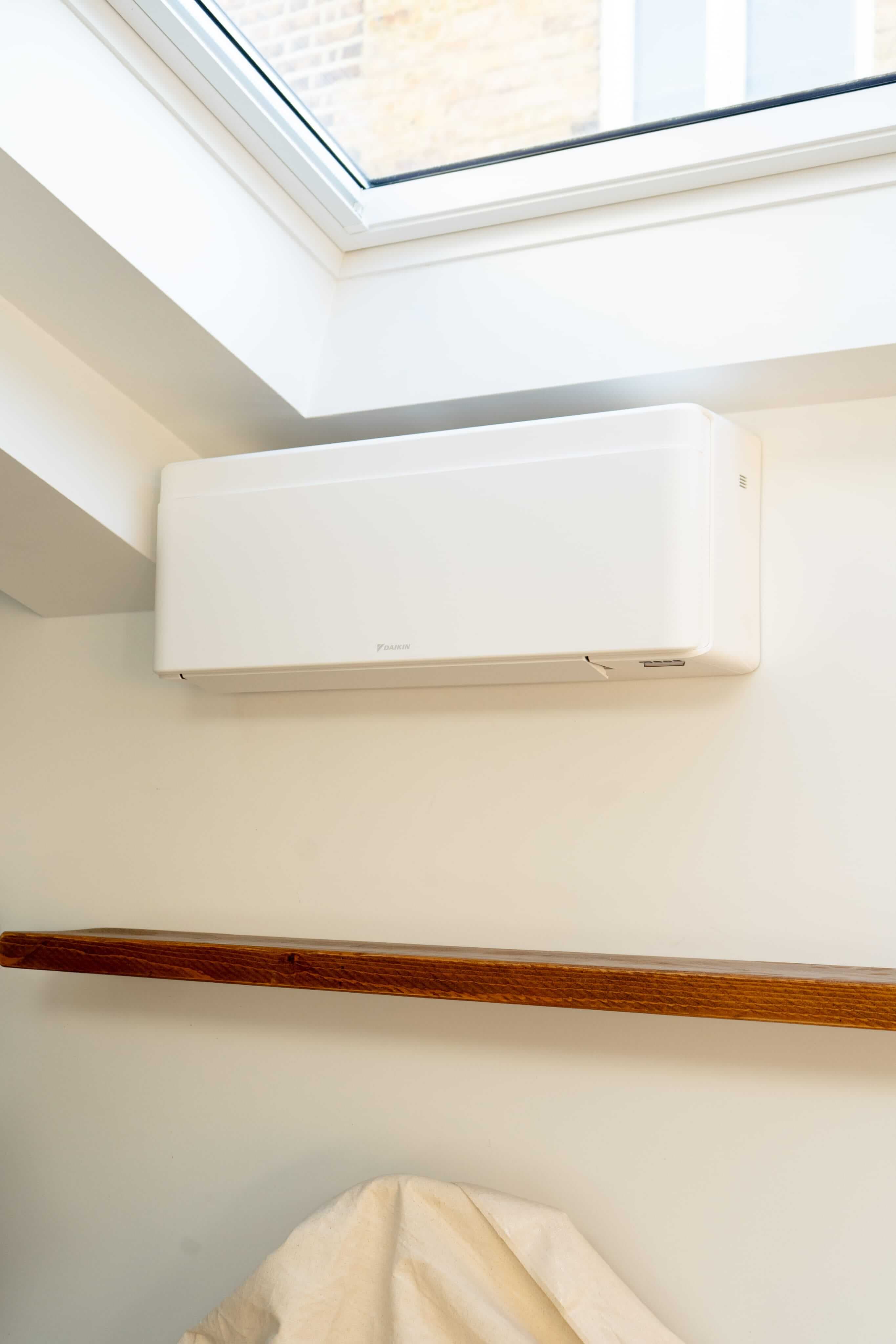 Commercial air conditioning unit installed in a bright room with skylights
