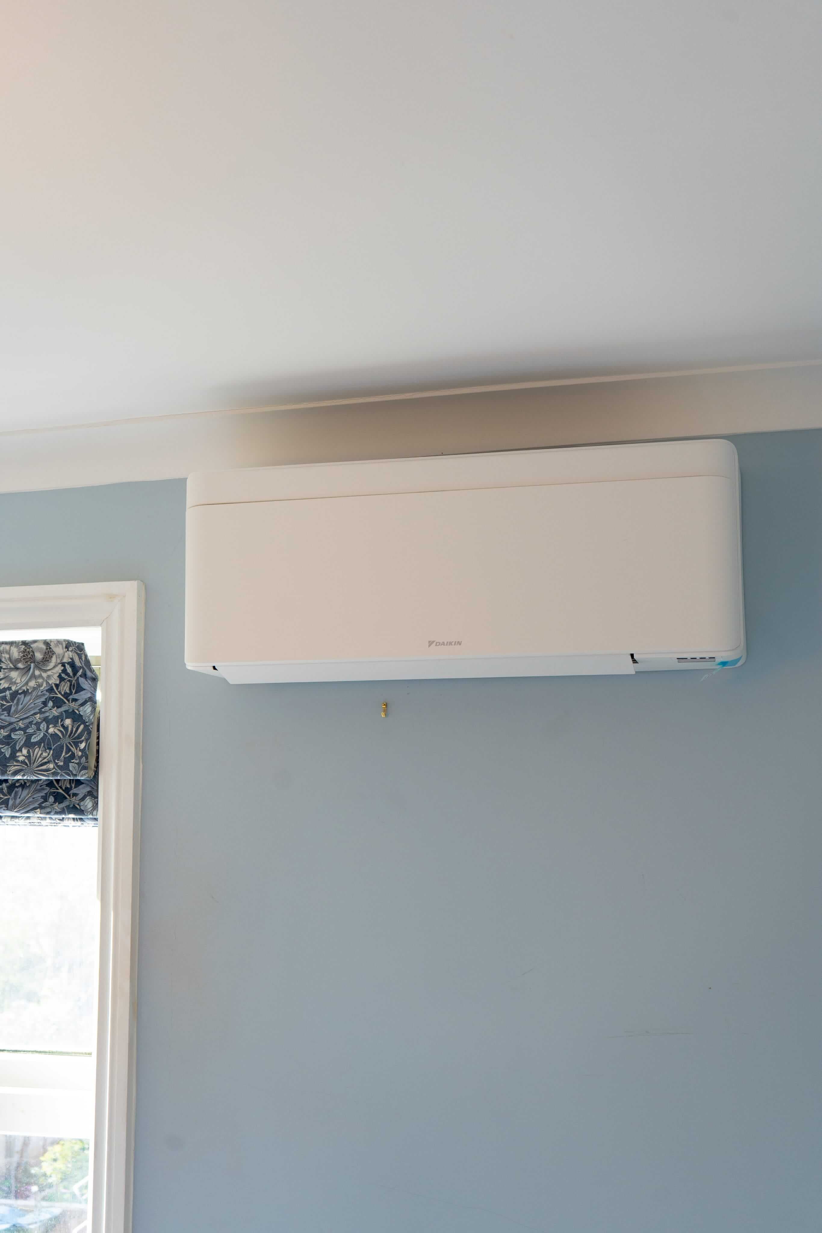 Domestic air conditioning unit mounted on a bedroom wall