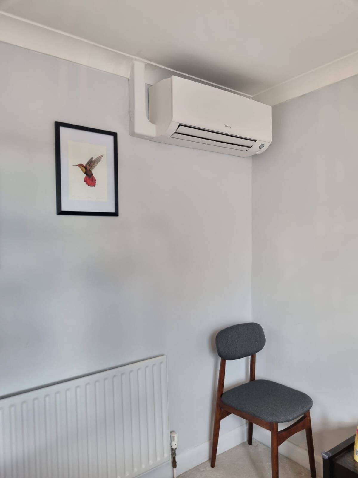 Sleek wall-mounted Daikin air conditioning unit in a minimal room
