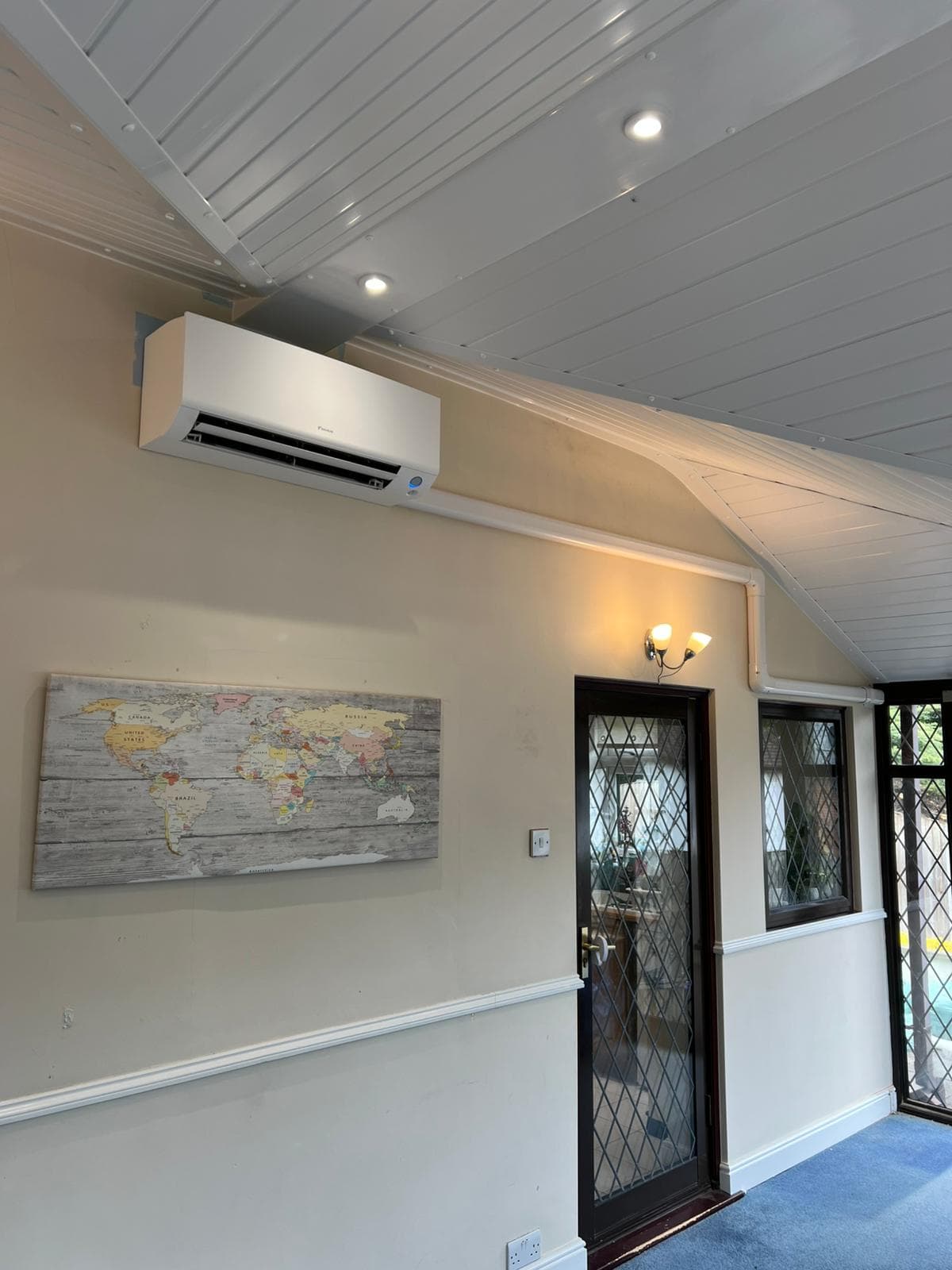Air conditioning unit in a bright conservatory with plants