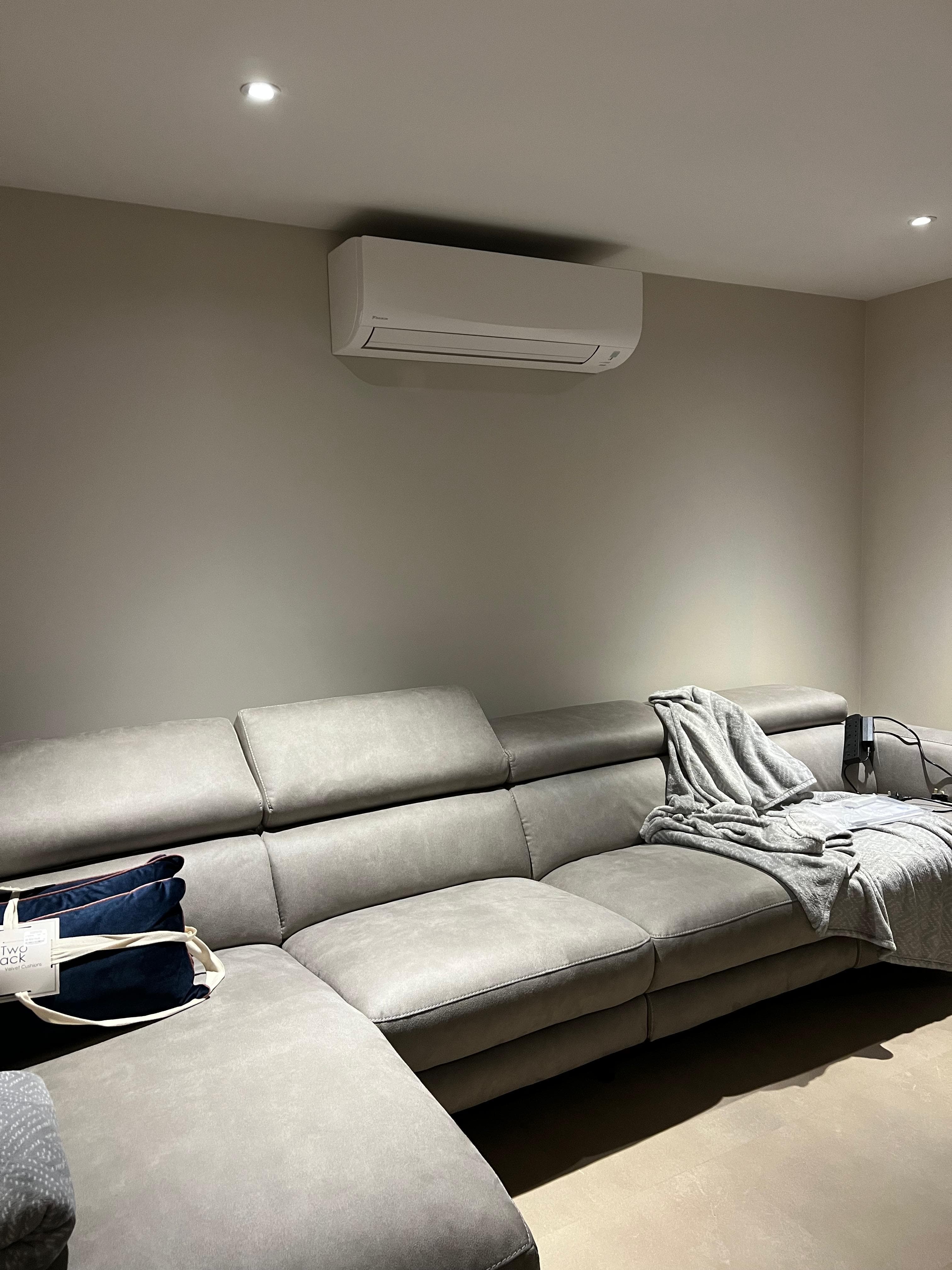 Air conditioning unit mounted in a modern lounge room