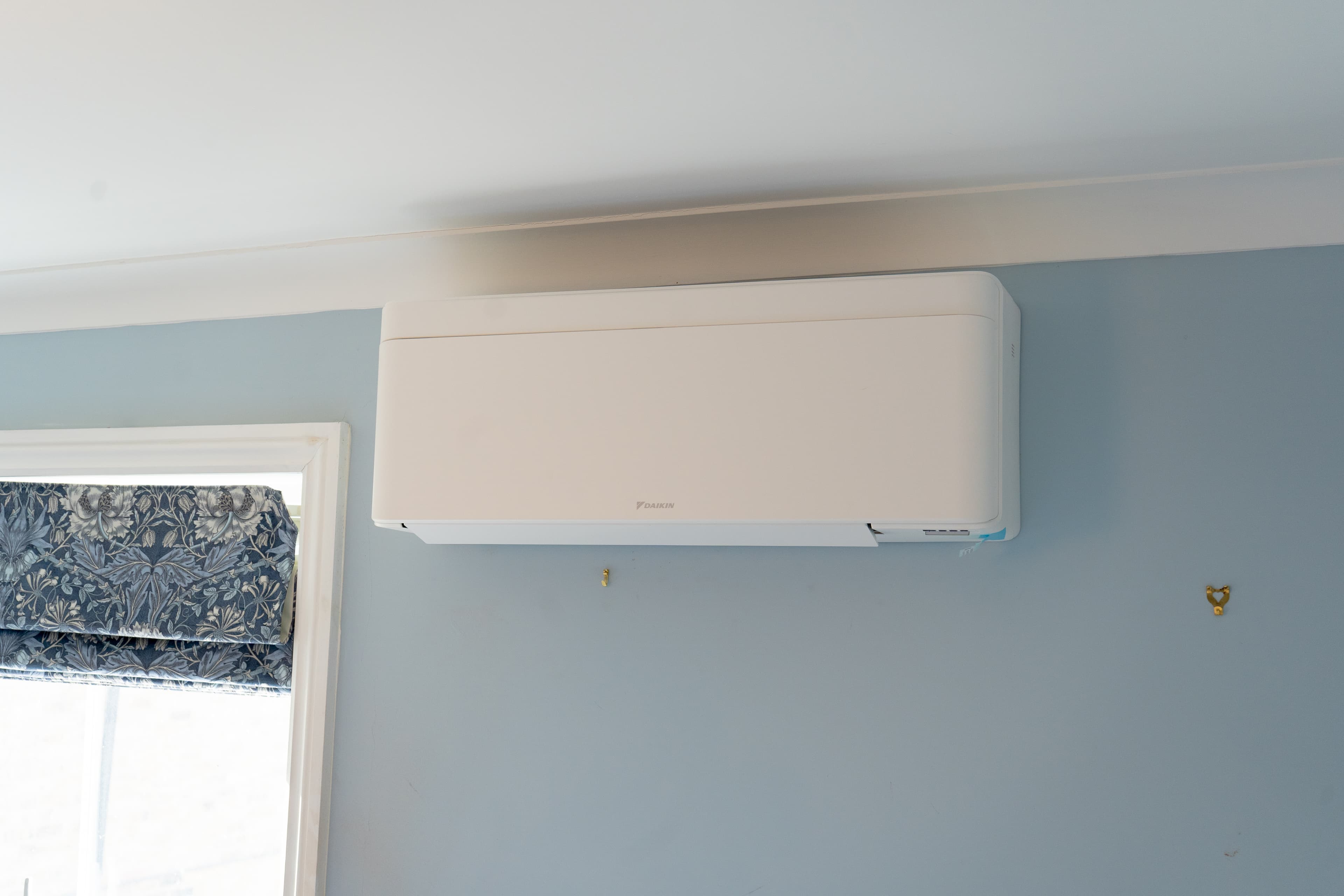 Daikin Stylish white wall-mounted air conditioning unit in a room