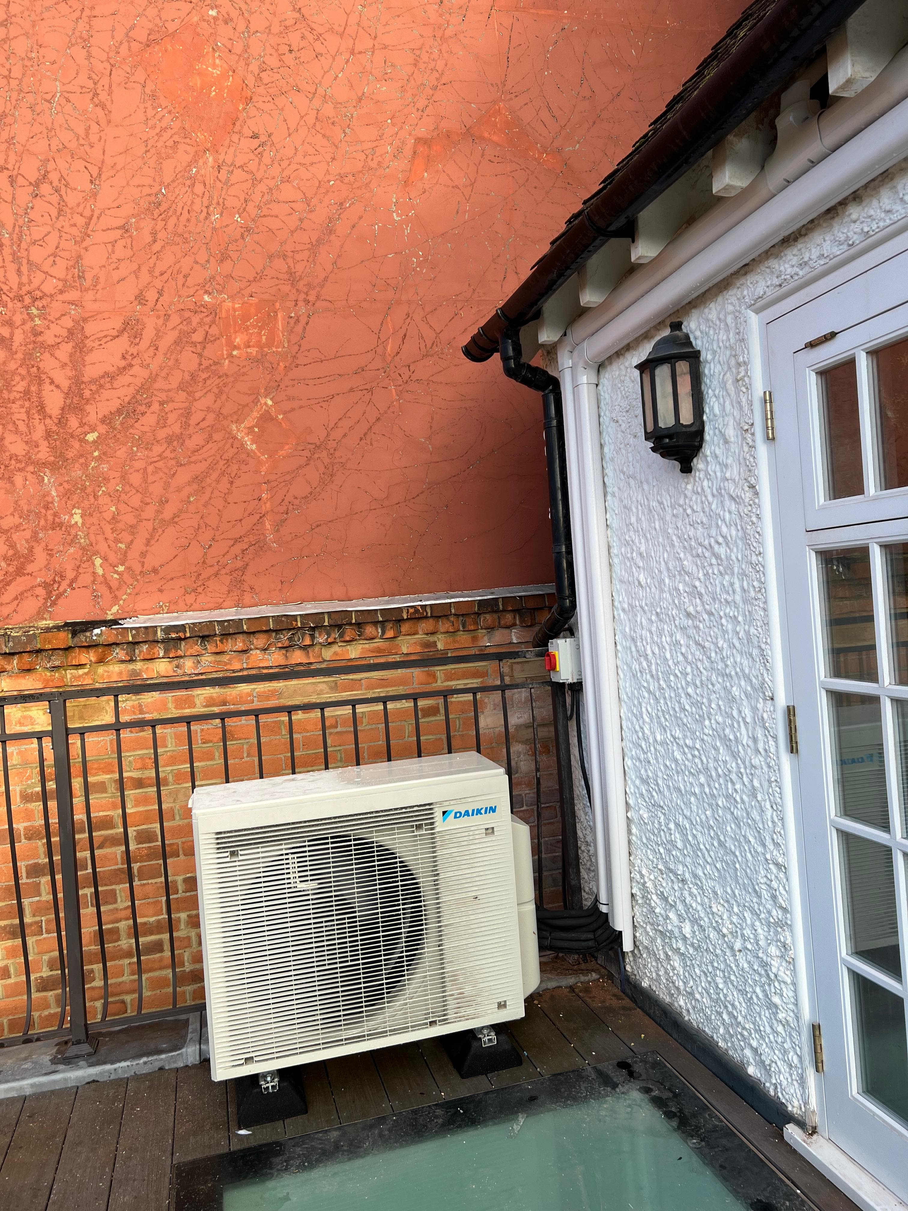 Outdoor AC unit placed on an extension roof