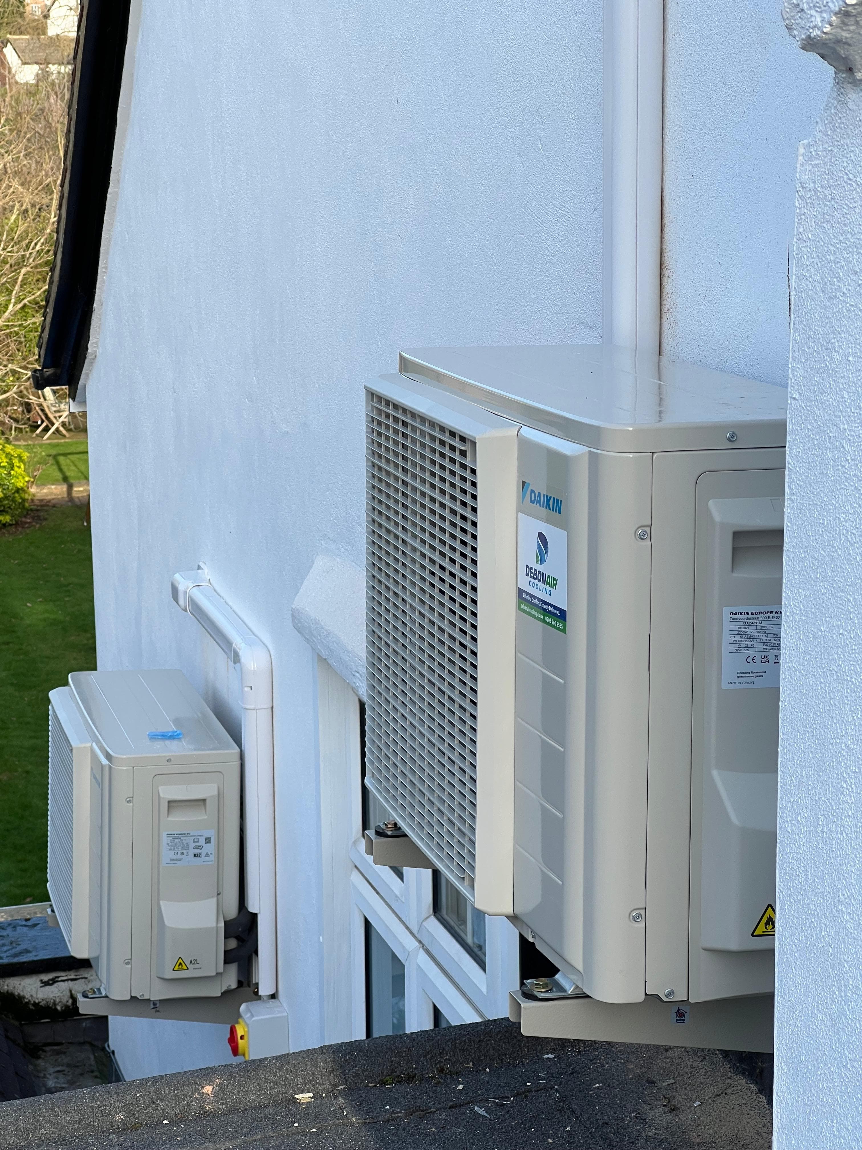 Condenser unit wall bracket on white rendered exterior wall