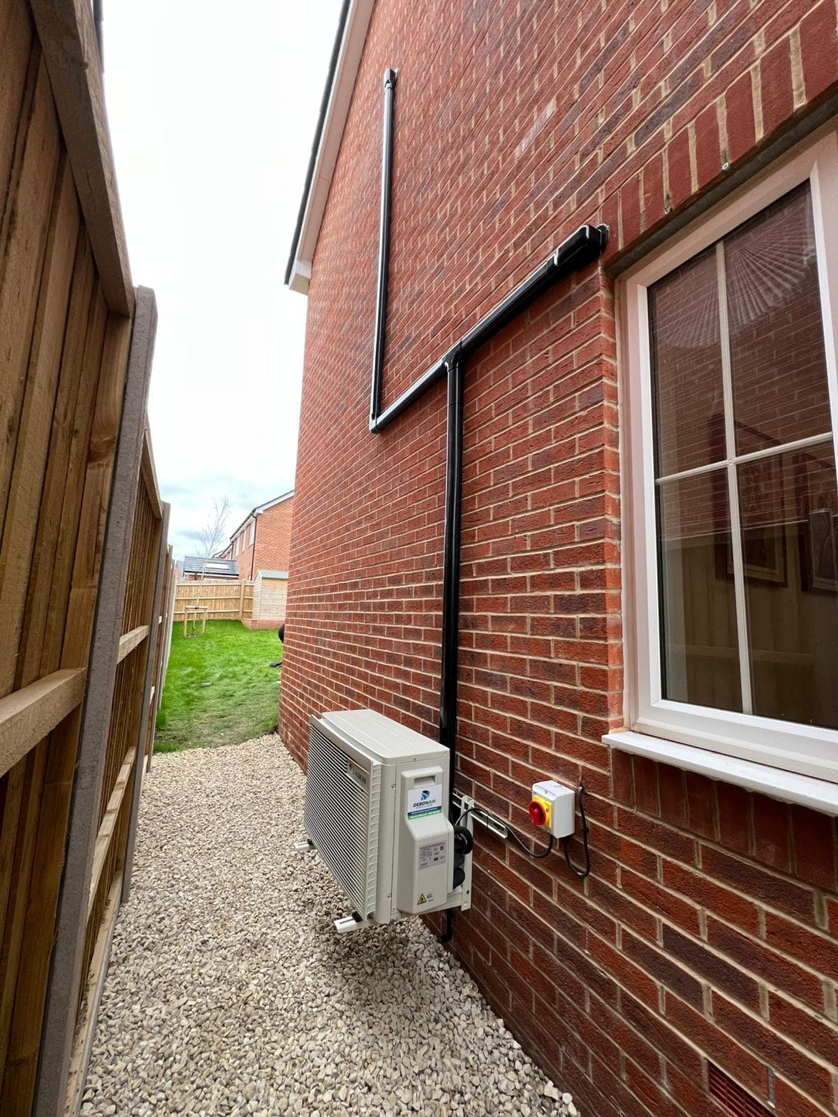 Black trunking with AC pipework - professional finish