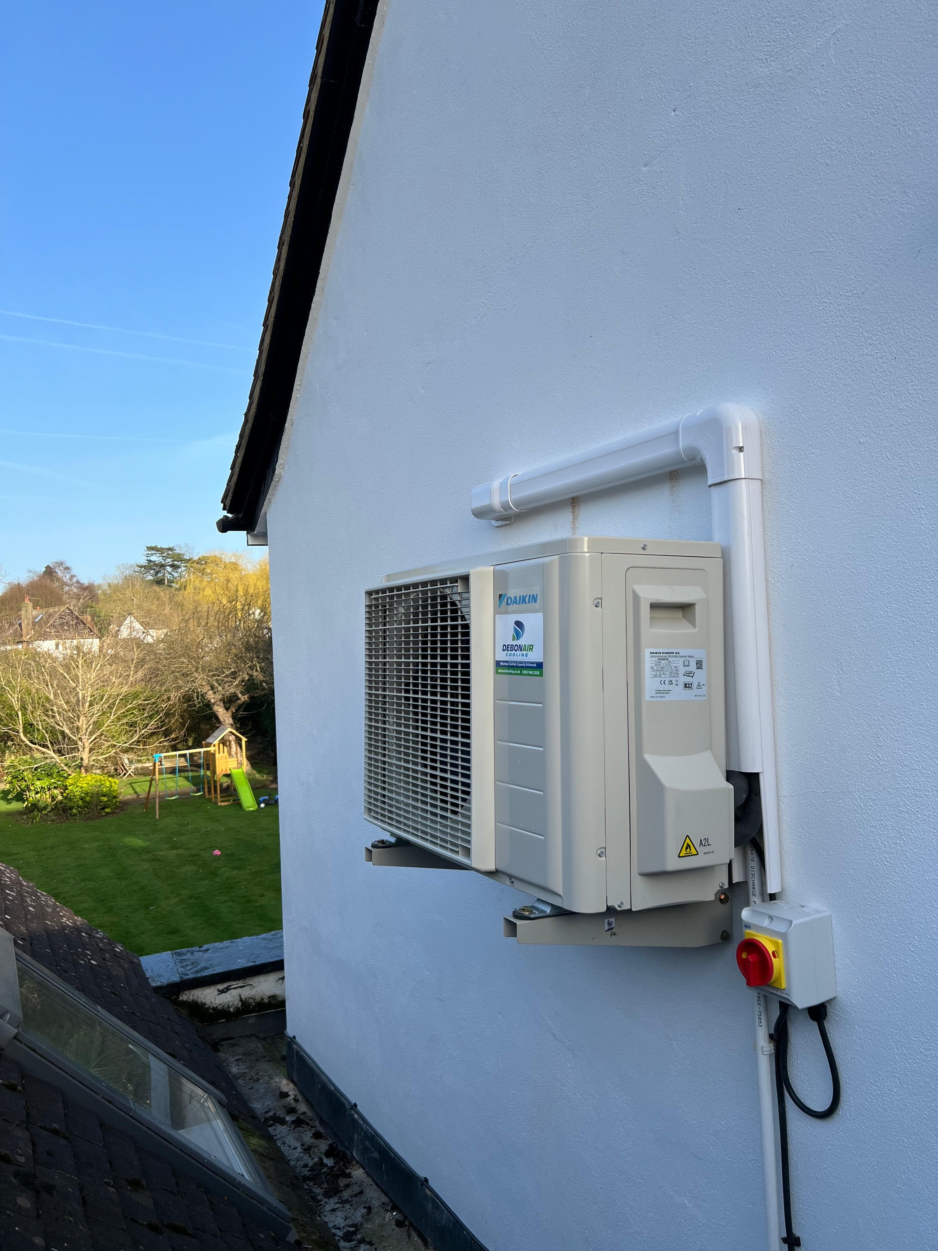 White trunking installed with AC pipework along a wall