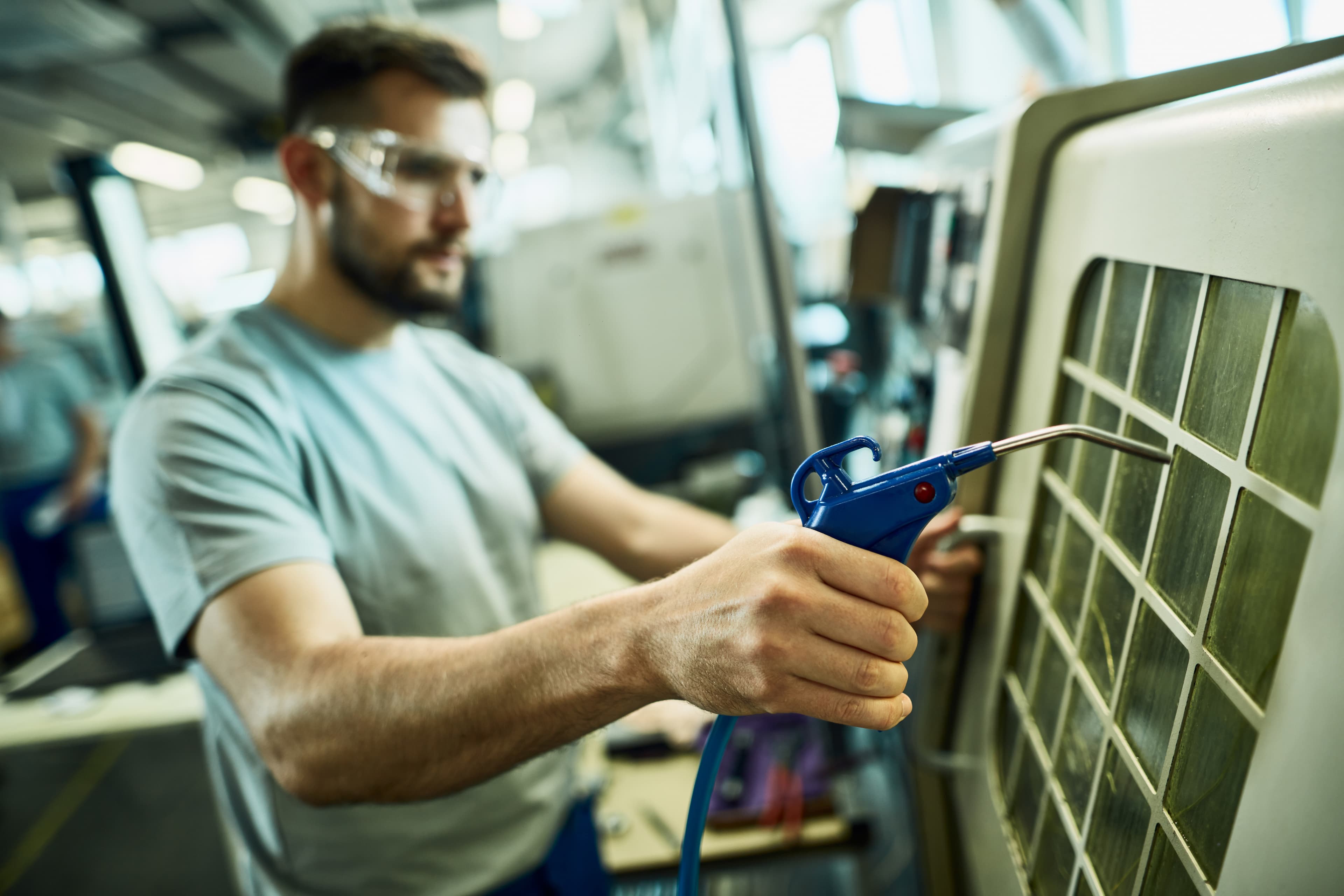 Engineer performing detailed workmanship checks on an AC condenser unit