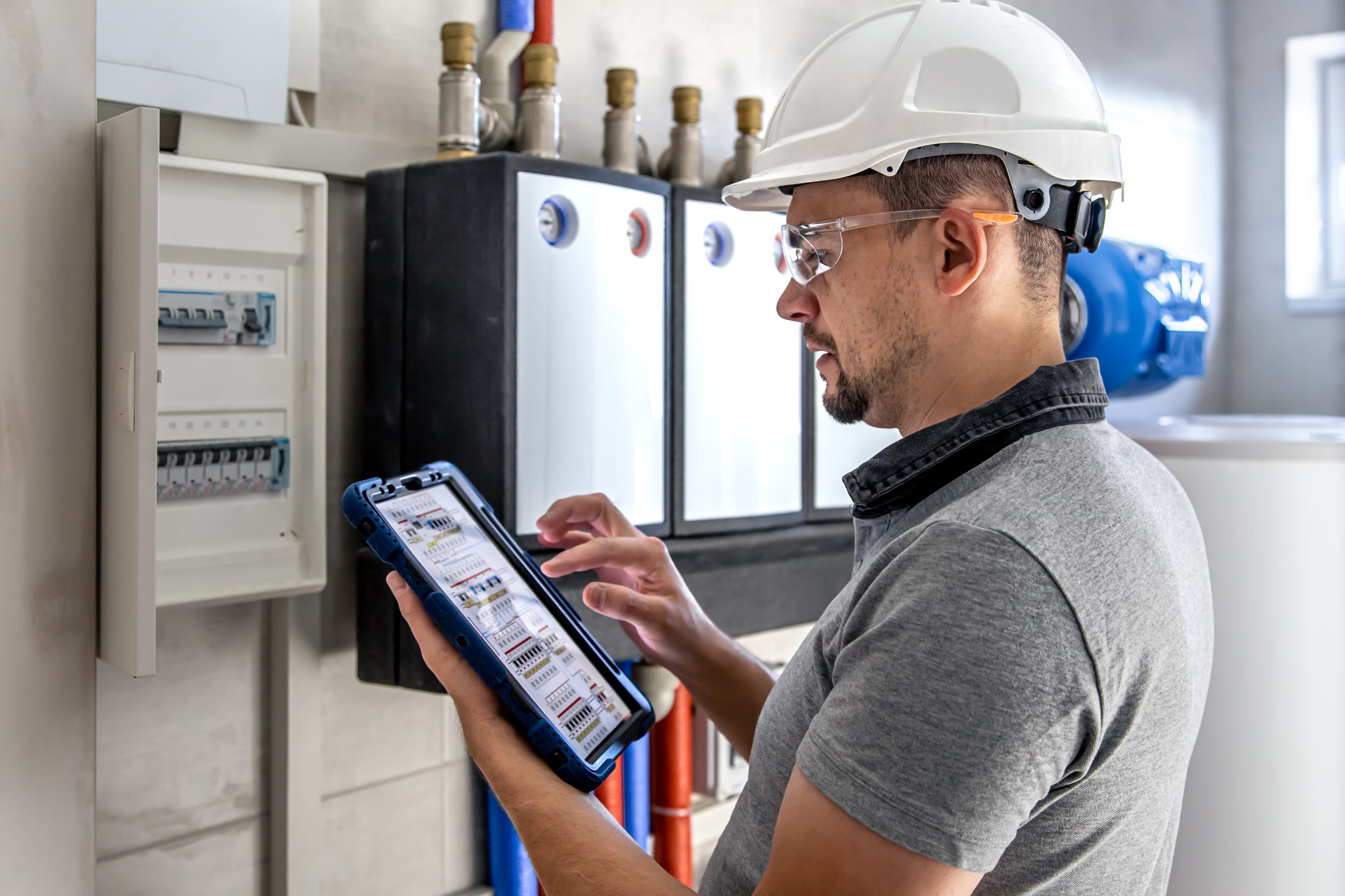 Engineer testing and commissioning installed air conditioning controls