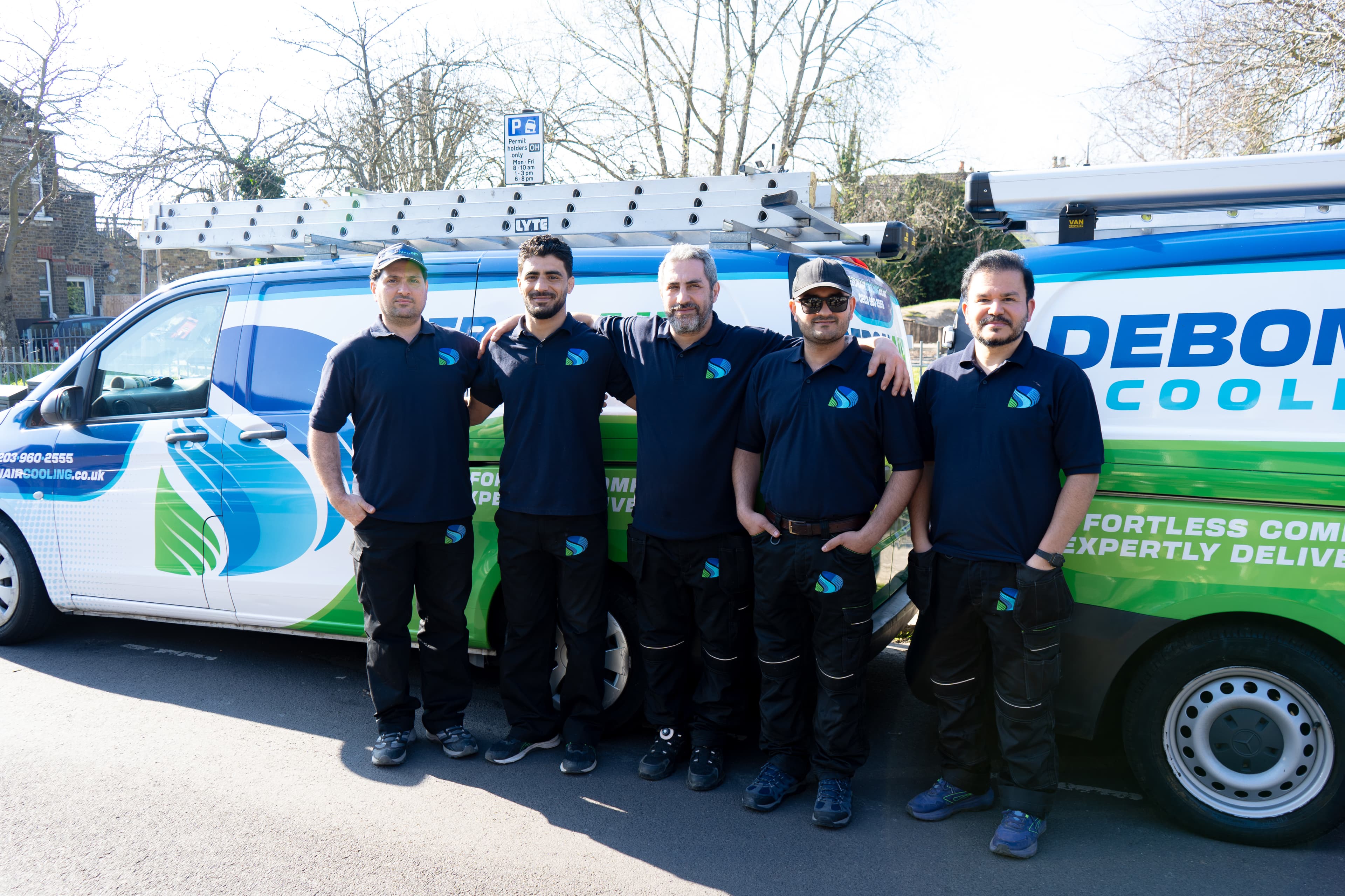 Debonair Cooling team in front of branded van