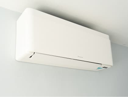 Air conditioning unit installed on exposed brick wall with pendant lamp