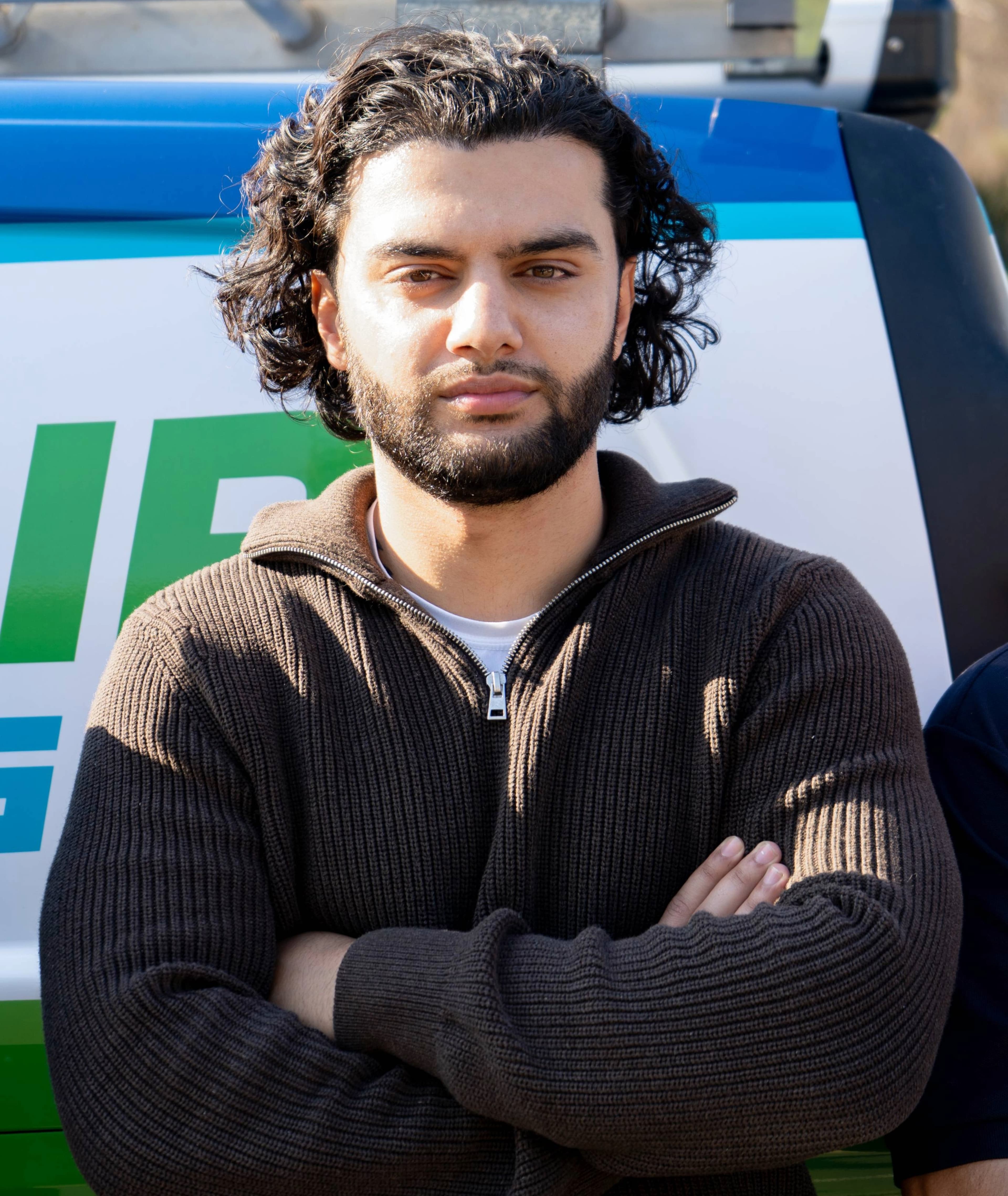 Aria Toupchiani standing in front of DebonAir vans